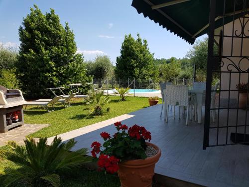 a patio with a table and chairs and a pool at Villa Ophelia in Ravi