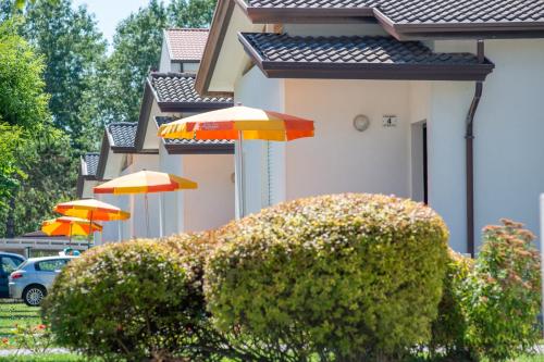 a row of umbrellas on the side of a house at Margherita Family Apartments in Cavallino-Treporti