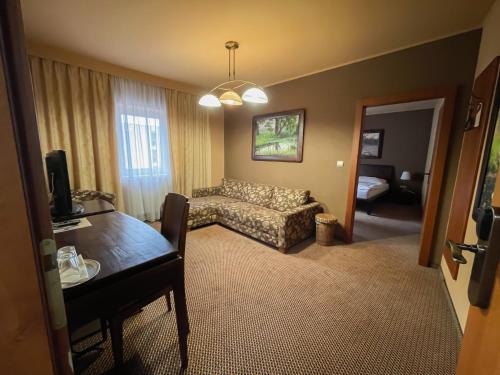 a living room with a couch and a table at Penzion Benedikti in Prievidza