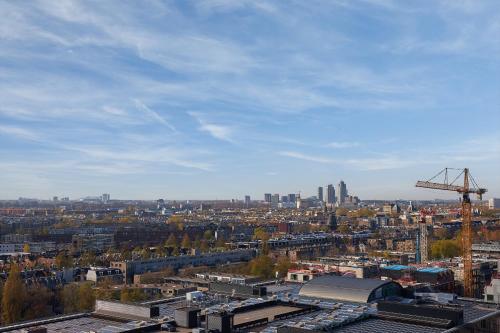 a view of a city with a crane and buildings at Inntel Hotels Amsterdam Landmark in Amsterdam