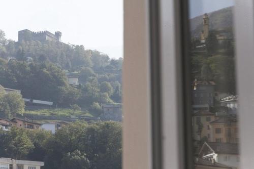 a view of a city from a window at Hotel Internazionale Bellinzona in Bellinzona