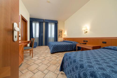 Postel nebo postele na pokoji v ubytování Hotel Giotto