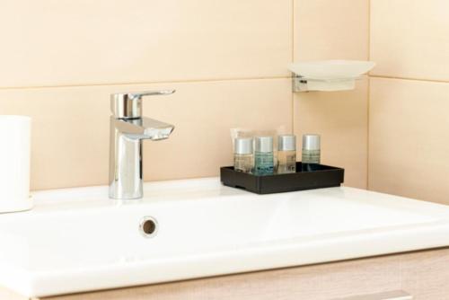 a sink in a bathroom with a faucet at Aurelia Antica Suites & Apartments in Rome