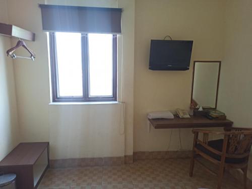 Una televisión o centro de entretenimiento en Al-Badar Hotel Syariah Makassar