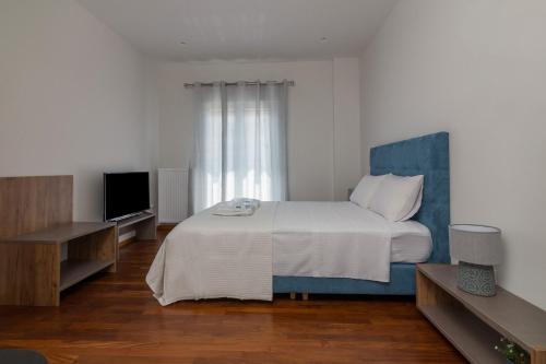 a bedroom with a bed and a flat screen tv at 105 Adrianou Plaka in Athens