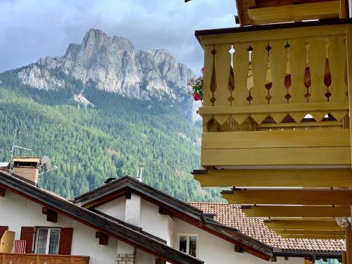 a view of a mountain from between two buildings at Casa di Franz in Vigo di Fassa