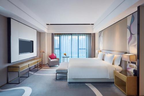 a hotel room with a bed and a television at Crowne Plaza Hangzhou Qiantang - The subway can reach the West Lake scenic area as well as the airport and high-speed rail station, adjacent to Jinsha Lake and Longfor paradise walk in Hangzhou