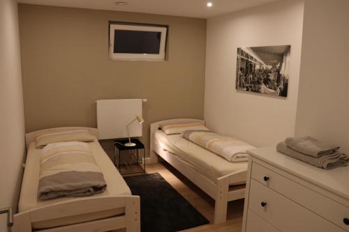 a room with two beds and a tv in it at Apartment "Marie" in ehemaliger Schuhfabrik in Herxheim