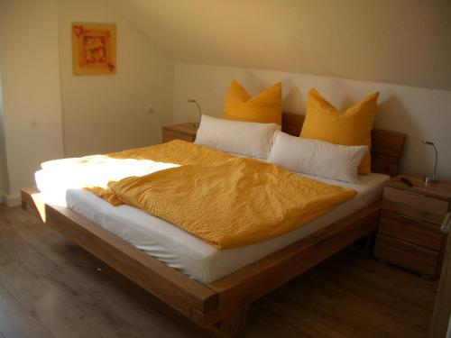 a bedroom with a large bed with yellow pillows at No Beach in Solingen