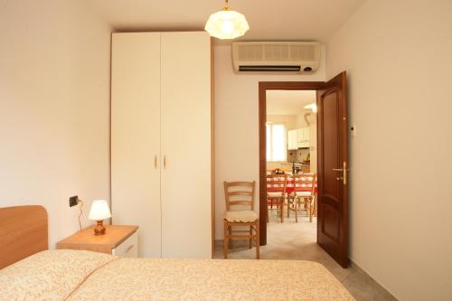 a bedroom with a bed and a door to a kitchen at Appartamenti In Piazzetta in Deiva Marina