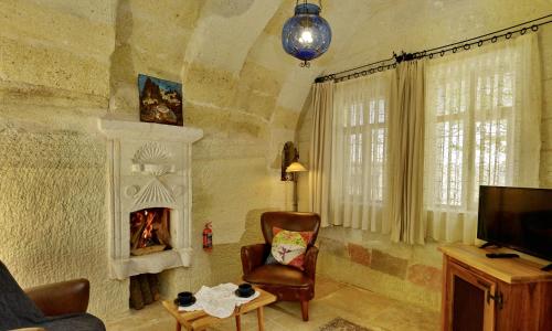 a living room with a chair and a fireplace at Seki Cave Suites in Goreme