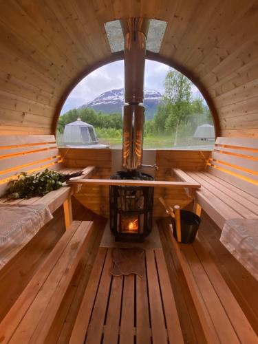 an inside view of a sauna with a wood stove at North Experience Basecamp in Melen
