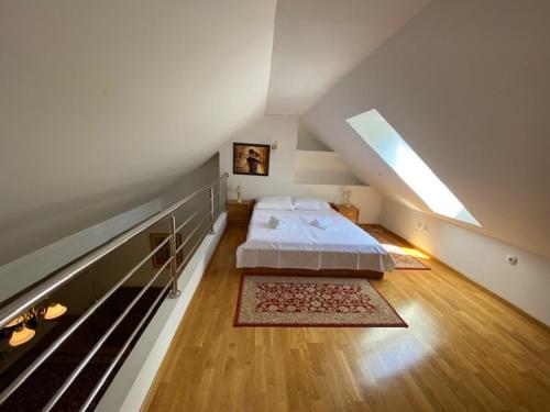 a bedroom with a large bed in a attic at VILA GOLF 32 in Rogaška Slatina