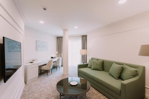 a living room with a couch and a table at Hotel Divine Park in Svilajnac