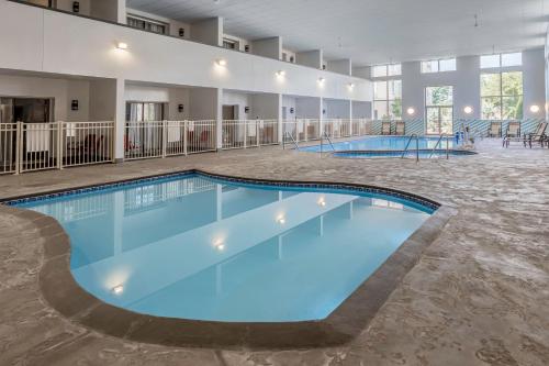 a large pool with blue water in a large building at Holiday Inn & Suites Wausau-Rothschild by IHG in Rothschild