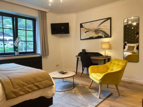 a bedroom with a bed and a desk and a chair at Villa Gracia in Namur