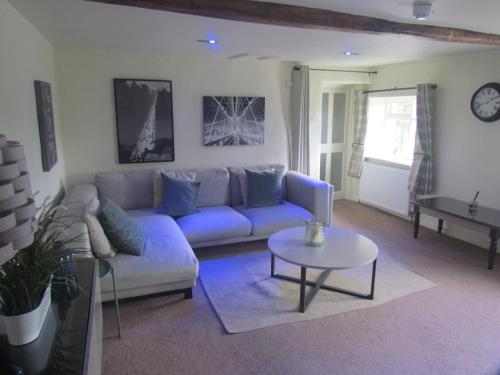 a living room with a blue couch and a table at The Sawley Arms in Ripon