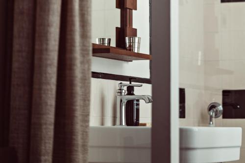 a bathroom with a sink and a shower curtain at Hotel des Académies et des Arts in Paris