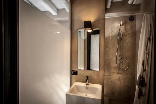 a bathroom with a sink and a mirror at Case D'a Mare Mondello in Mondello