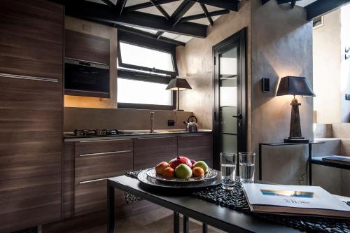 a kitchen with a table with a bowl of fruit on it at Case D'a Mare Mondello in Mondello