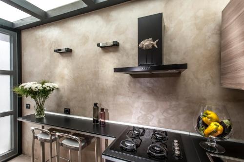 a kitchen with a stove and a counter top at Case D'a Mare Mondello in Mondello
