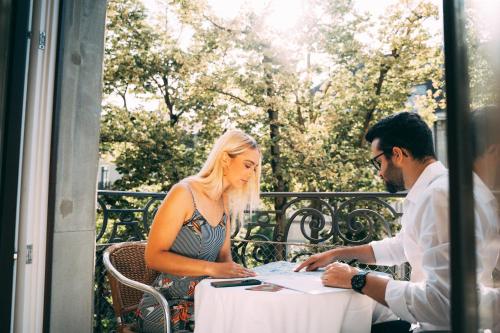 a man and a woman sitting at a table at Hotel St.Gotthard in Zürich