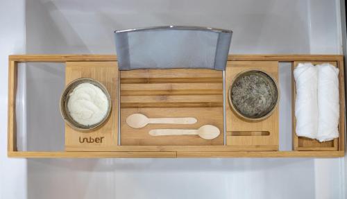 a wooden shelf with two bowls and towels on it at Amanti, MadeForTwo Hotels - Ayia Napa in Ayia Napa