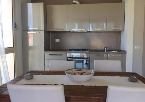 a kitchen with a table with chairs and a bowl on it at KatlantiK Ca Madeira Deluxe in Sal Rei