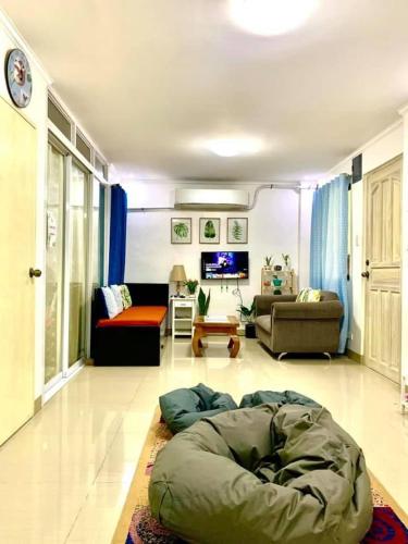 a living room with a bean bag bed on the floor at Cozy Central - Near arca south signal taguig in Manila