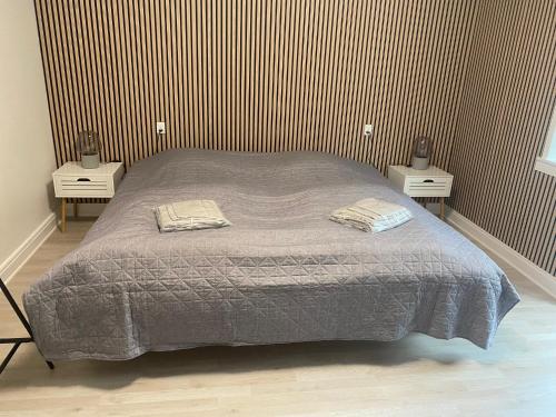 a bedroom with a bed with two nightstands and two tables at Just Sleep Delux in Brande