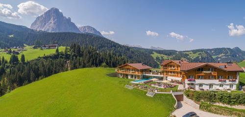 an aerial view of a house in the mountains at Hotel Rodella in Selva di Val Gardena