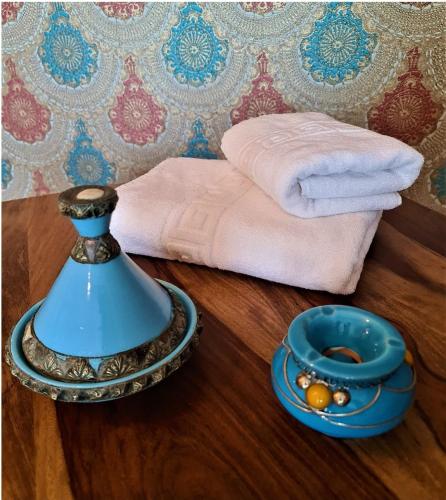 a blue vase on a table next to a towel at Kaleidoscope Boutique Hotel in Craiova