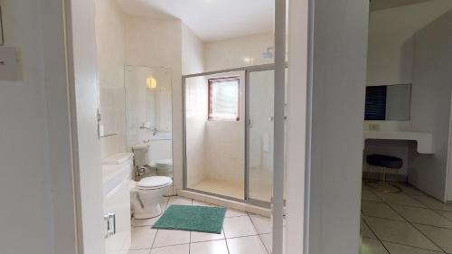 a bathroom with a toilet and a glass shower at San Lameer Villa 1928 by Top Destinations Rentals in Southbroom