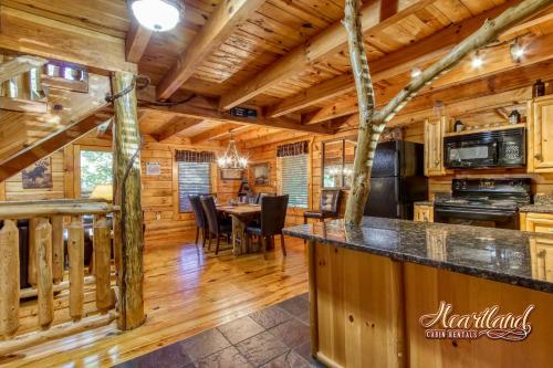 a dining room and kitchen in a log cabin at God's Grace in Pigeon Forge