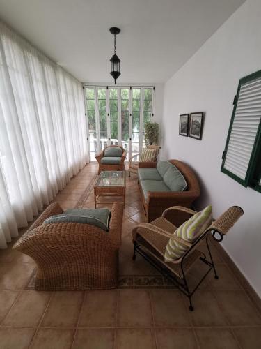 a living room with wicker chairs and a couch at CASA rural DOLORES en Adeje in Adeje