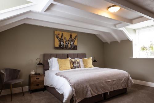 a bedroom with a large bed and a window at The Derwent Arms in Edmondbyers