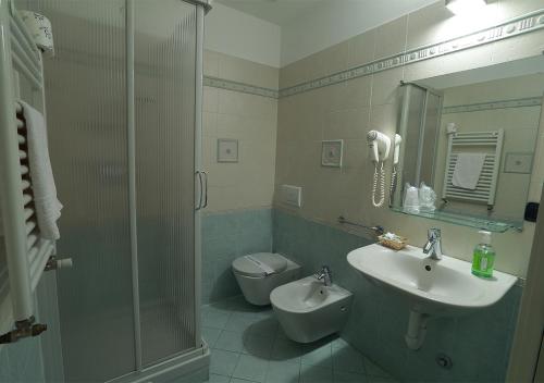 a bathroom with a sink and a toilet and a shower at Caprice in Avigliana