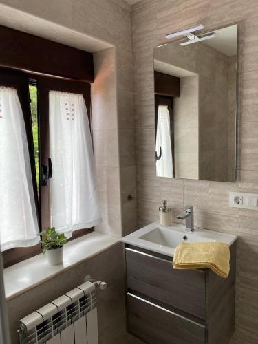 a bathroom with a sink and a mirror at Las tres Luces Casa 2 in Picones