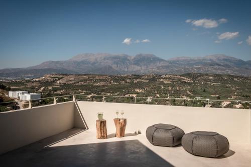 a balcony with a view of the mountains at Kamilari Luxury Residences in Kamilari