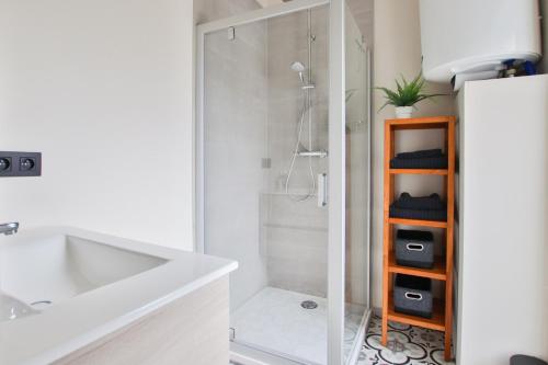 bagno bianco con doccia, lavandino e doccia di La Cense de Baudecet - Les Écuries a Gembloux