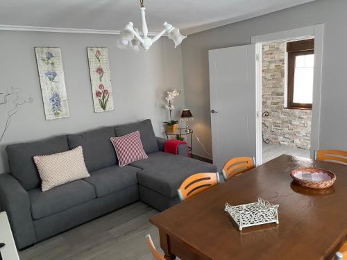 a living room with a couch and a table at Las tres Luces Casa 2 in Picones