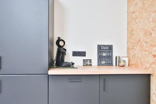 a kitchen with a counter and a refrigerator at La Cense de Baudecet - La Fabrique in Gembloux