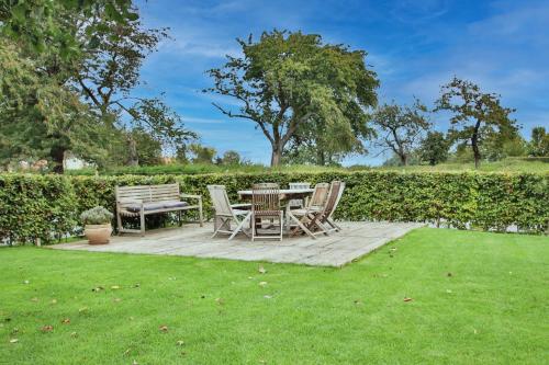 a patio with a table and chairs in a yard at La Cense de Baudecet - Le Corps de Logis in Gembloux