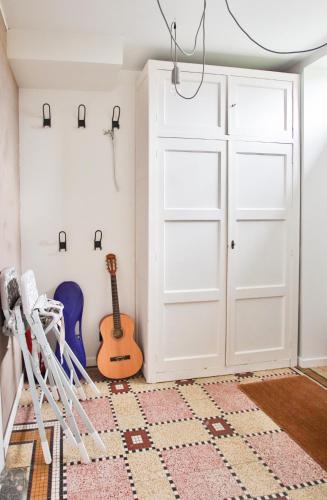 a room with a white door and a guitar at La Cense de Baudecet - Le Corps de Logis in Gembloux