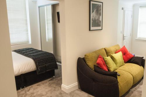 a living room with a couch and a bed at The Ship Leopard Hotel - No Children in Portsmouth