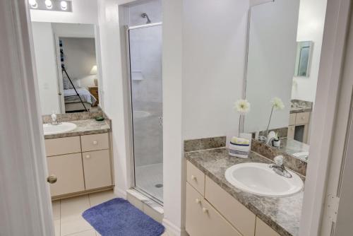ein Badezimmer mit zwei Waschbecken und einer Dusche in der Unterkunft Magical Fiesta Key Townhouse in Kissimmee