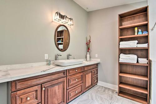 a bathroom with a sink and a mirror at Renovated Lakeside Home with Private Boat Dock! in Pine Crest