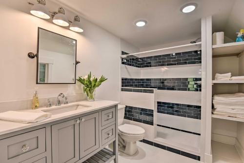 a bathroom with a sink and a toilet and a mirror at Renovated Lakeside Home with Private Boat Dock! in Pine Crest