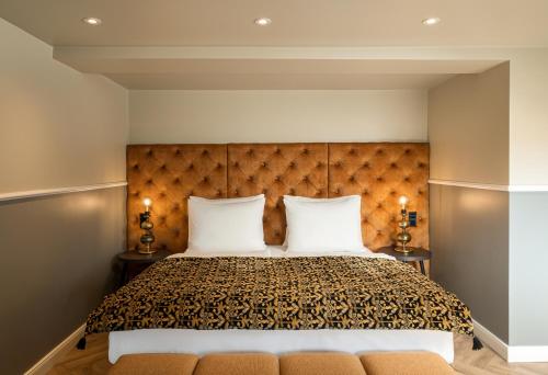 a bedroom with a large bed with two white pillows at Maison Viktoria Augsburg in Augsburg