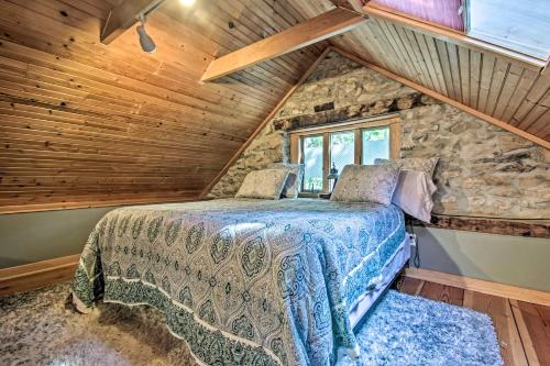 a bed in a room with a stone wall at Mercersburg Cottage, 7 Mi to Whitetail Resort in Mercersburg